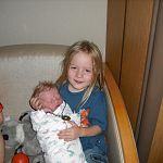 Skye holding his new sister