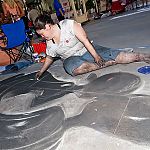 Barefoot street chalk artist with dirty feet and legs