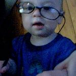 Noah wearing my glasses